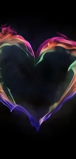 Vibrant heart-shaped flame on dark background wallpaper.