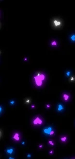 Neon pink, blue, and white glowing hearts on a black background.