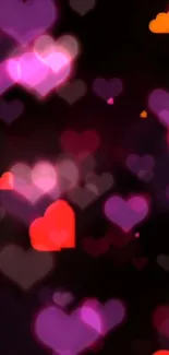 Colorful heart wallpaper with glowing pink and red hues on a dark background.