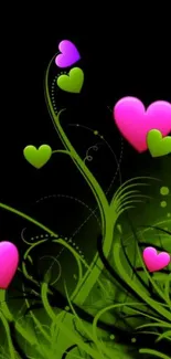 Vibrant wallpaper with pink and green hearts on a black background.