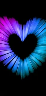 Neon heart with pink and blue hues on a black background.