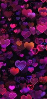 Glowing colorful hearts on dark background wallpaper.