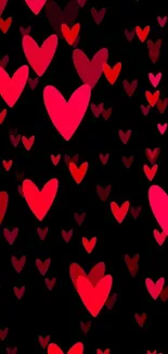 Vibrant red and pink hearts on a black background wallpaper.