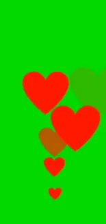 Mobile wallpaper with red hearts on a green background.