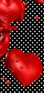 Red 3D hearts on black and white polka dot background.