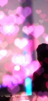 Colorful bokeh hearts with silhouette in background.