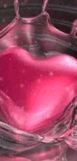 Heart shaped splash in vibrant pink liquid on phone wallpaper.