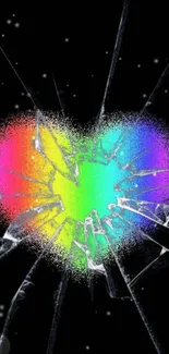 A cracked heart with a rainbow splatter on a black background.