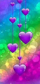 Vibrant purple hearts with bokeh on rainbow background.