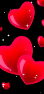 Glossy red hearts with sparkles on a black background wallpaper.