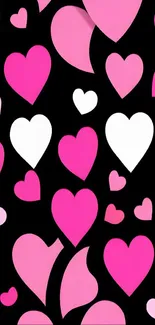 Pink and white hearts on a black background wallpaper.