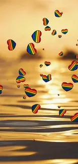 Colorful heart balloons float over a golden sunset on the ocean.