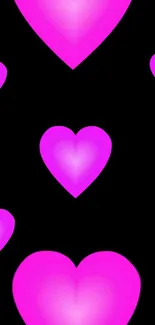 Mobile wallpaper with glowing pink hearts on black.