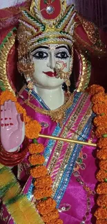 Colorful Hindu deity sculpture with vibrant garlands.