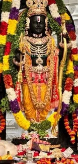 Vibrant Hindu deity adorned with colorful garlands in traditional attire.