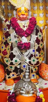 Hindu deity with colorful floral garlands and radiant background.