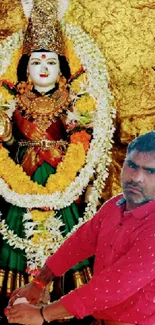 Hindu goddess adorned with garlands in a vibrant shrine setting with a devotee.