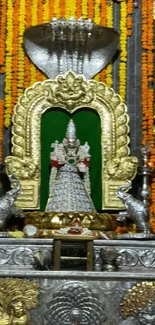 Ornate Hindu deity with vibrant backdrop.