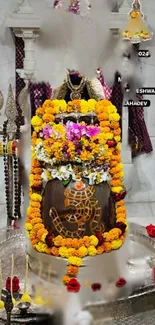 Hindu temple shrine adorned with colorful flowers.