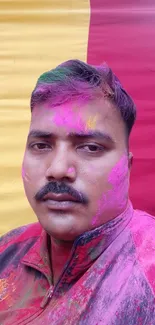 Vibrant Holi portrait with colorful powders and festive background.