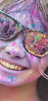 Joyful face with colored Holi festival splashes wearing sunglasses.