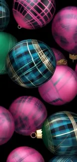 Colorful plaid holiday ornaments on black background.