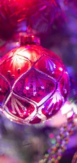 Glittering red ornament on festive tree.