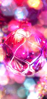 Colorful Christmas ornament on a tree with vibrant purple and red hues.