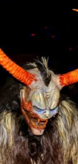 Mythical creature with vibrant orange horns on a dark background.