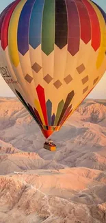 Colorful hot air balloon over desert landscape.