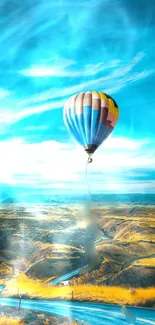 Vivid hot air balloon in blue sky over scenic landscape.