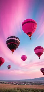 Vibrant hot air balloons in a pink sky, creating a scenic view.