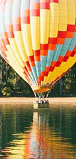 Colorful hot air balloon over a serene lake.