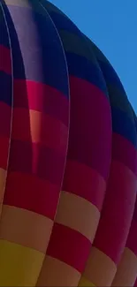 Colorful hot air balloon against a blue sky.