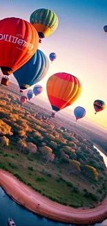 Hot air balloons floating over a river at sunset.