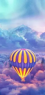 Vibrant hot air balloon floats over mountains and clouds.