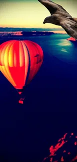 Vibrant hot air balloon over a scenic sunset with bird in sky.