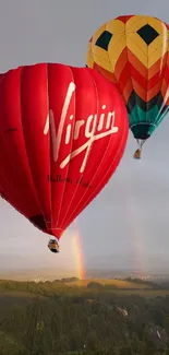 Colorful hot air balloons with a rainbow in the sky.