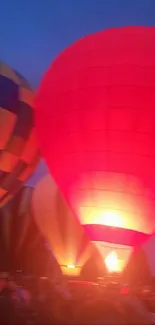 Bright hot air balloons glowing against a deep evening sky.