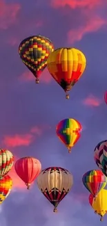 Colorful hot air balloons against a purple sky.