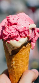 Picture of a pink ice cream cone in focus.