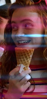 Girl smiling with ice cream cone and colorful neon lights.