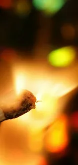 Close-up of a matchstick igniting with colorful bokeh background.