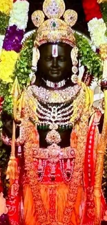 Colorful Indian deity adorned with jewelry and garlands.