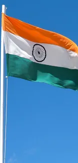 Indian flag waving against a bright blue sky.