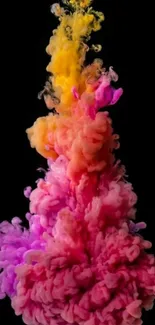 Vibrant pink, orange, and yellow ink cloud on black background.