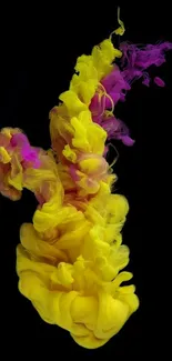 Vibrant yellow and magenta ink splash on black background wallpaper.