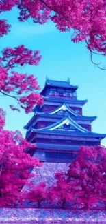 Japanese castle surrounded by pink cherry blossoms.