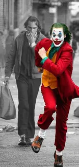 Joker in red suit running on monochrome street.