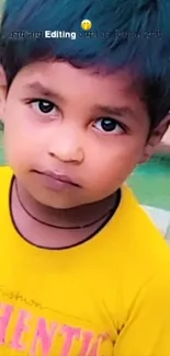 Cute child in a yellow shirt with a curious expression on a colorful background.